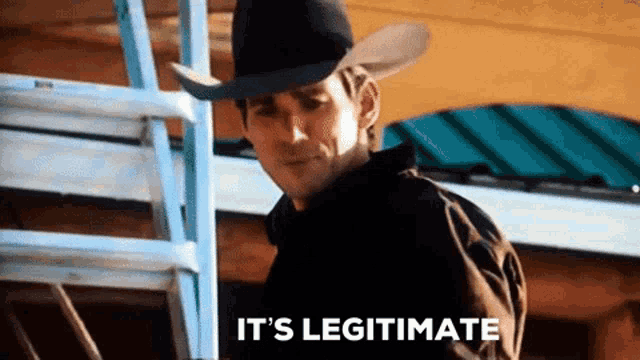 a man in a cowboy hat says it 's legitimate while standing on a ladder