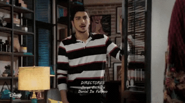 a man in a striped shirt is standing in a room with the words directores written on the bottom