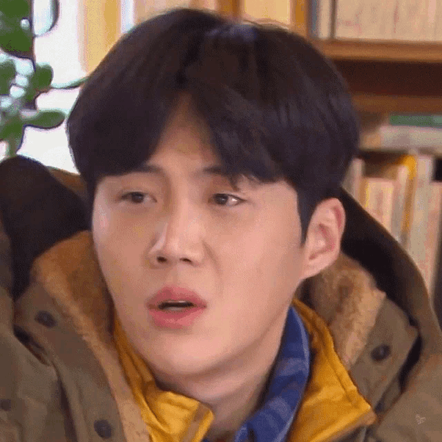 a close up of a person 's face with a surprised look on his face .