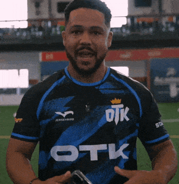 a man wearing a jersey that says otk