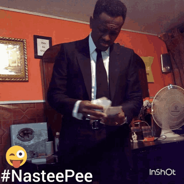 a man in a suit and tie is holding money in his hands