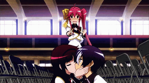 a girl with red hair is kissing a boy in front of a crowd of chairs