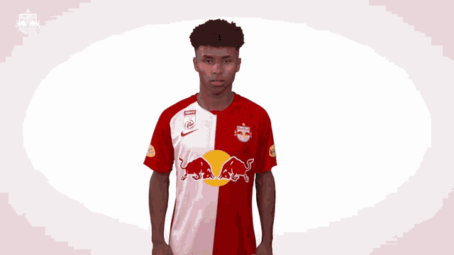 a man wearing a red and white red bull shirt