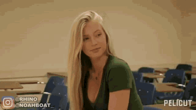 a woman in a green top is sitting in a classroom with a pelicut logo on the bottom