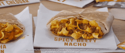 a taco with spicy beefy nacho on a white paper