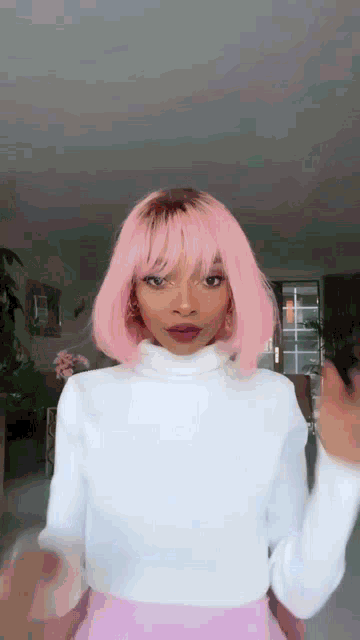 the woman is wearing a pink wig and a white turtleneck .