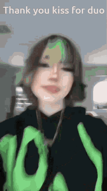 a girl is wearing a green shirt that says " thank you kiss for duo " on it