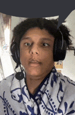 a young man wearing headphones has a speech bubble above his head that says tik tok