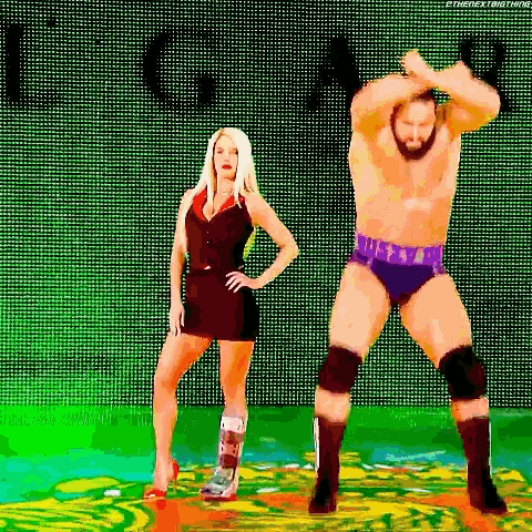 a man and a woman are standing next to each other in front of a green background .