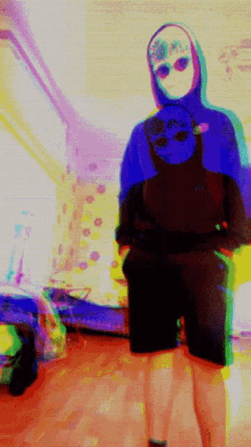 a blurry picture of a person wearing a hoodie with a skull on it