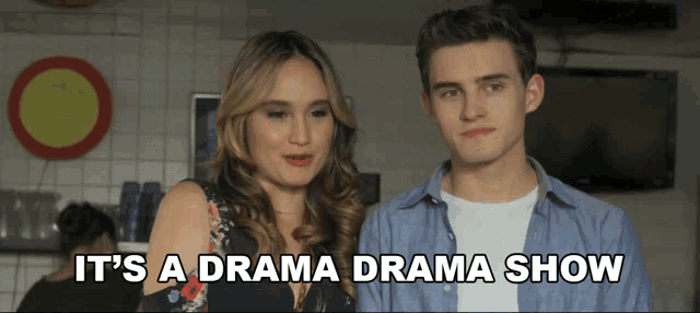 a man and a woman standing next to each other with the words " it 's a drama drama show "