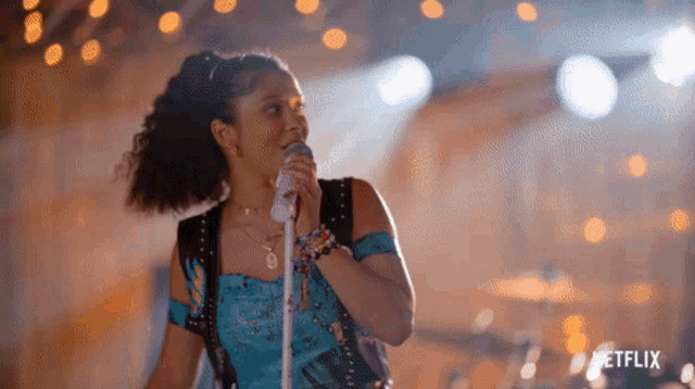 a woman singing into a microphone with the netflix logo in the corner