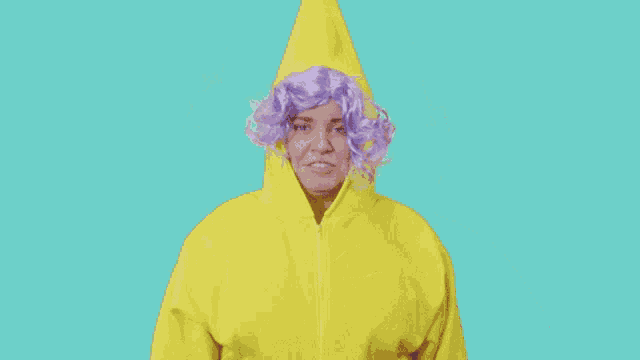 a woman wearing a yellow hoodie and purple wig is crying