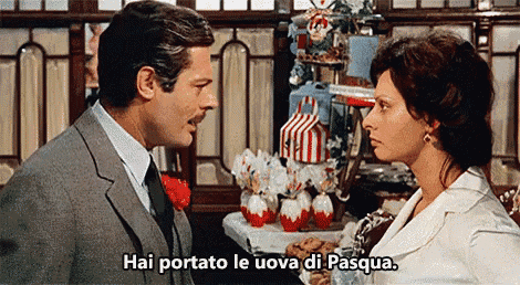 a man and a woman are standing next to each other and the woman says hai portato le uova di pasqua .