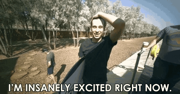 a man holding a surfboard with the words i 'm insanely excited right now