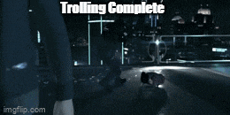 a man in a suit is walking down a street with the words trolling complete behind him
