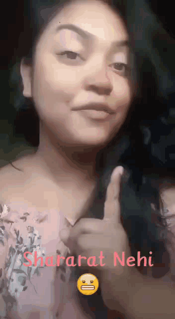 a woman giving a thumbs up with the words shararat neii behind her