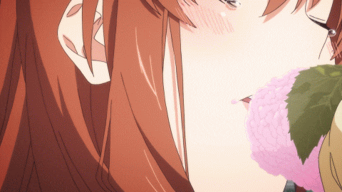 a close up of a woman 's face with a flower in her mouth