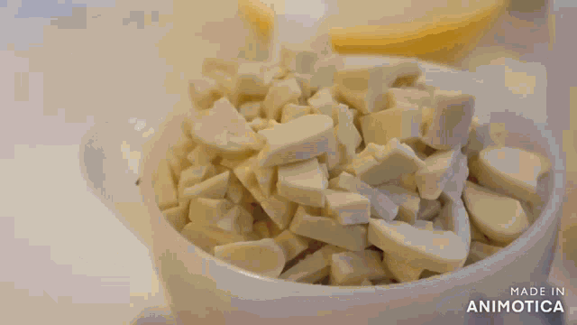a piece of butter is being whisked in a bowl with a whisk .