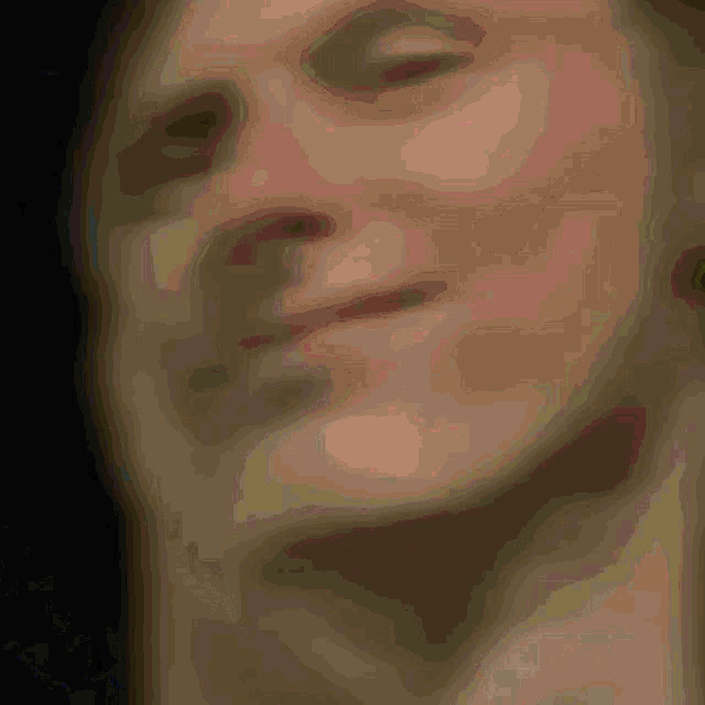a close up of a person 's face with a black background