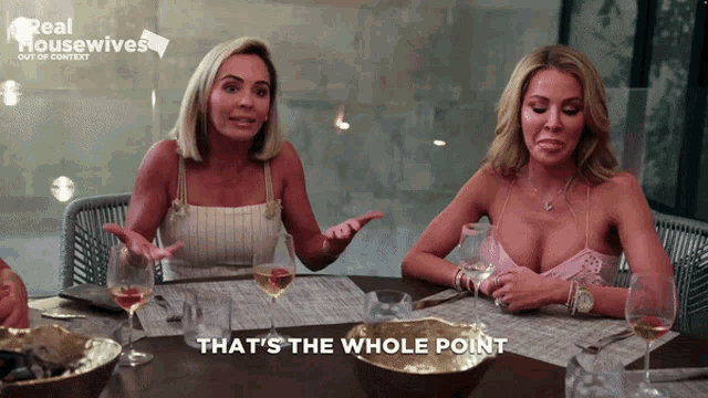 two women are sitting at a table with the words that 's the whole point on the bottom