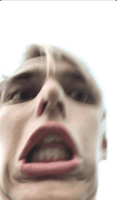 a close up of a person making a funny face with their mouth open