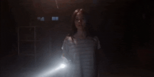 a woman is surrounded by glowing lights and hearts