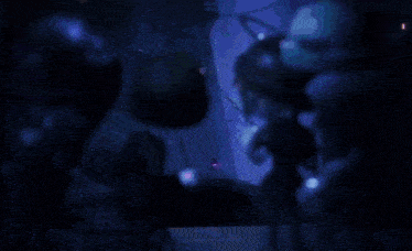 a silhouette of a person in a dark room with chains
