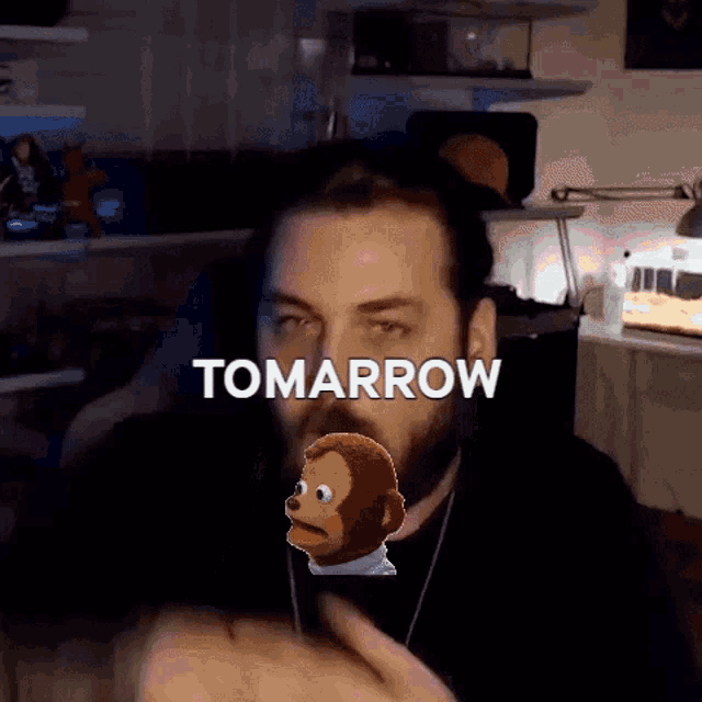 a man with a monkey behind him and the word tomorrow
