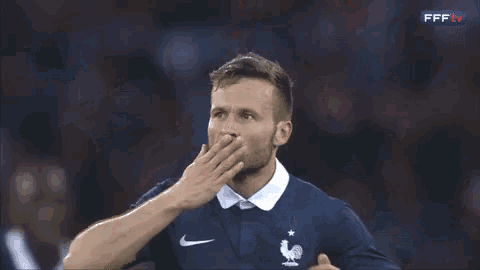 a soccer player wearing a blue nike jersey with a french flag on it