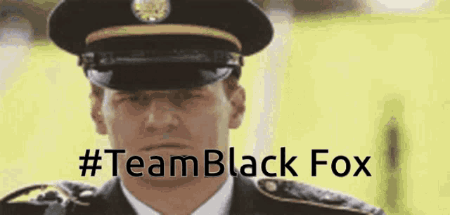 a man in a military uniform with the hashtag #teamblack fox written below him