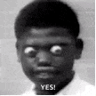 a black and white photo of a boy with big eyes and the words `` yes '' on his face .