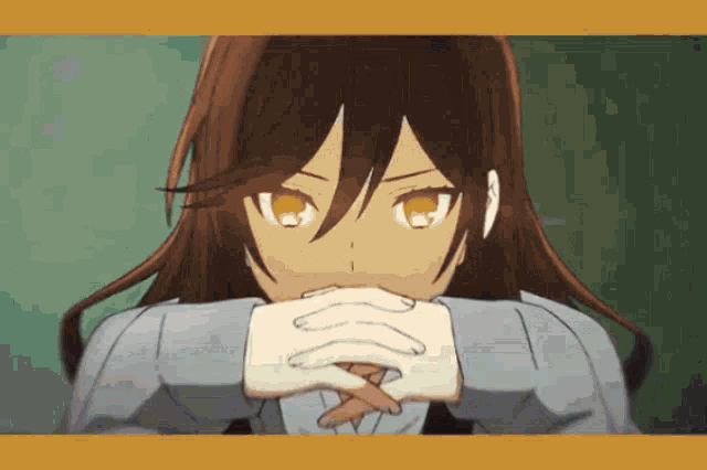 a close up of a girl with her hands folded in front of her face
