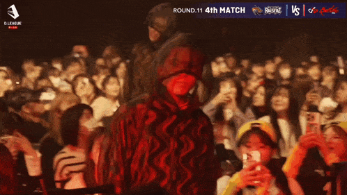 a man in a red hoodie is standing in front of a crowd with the words hokuto on the bottom
