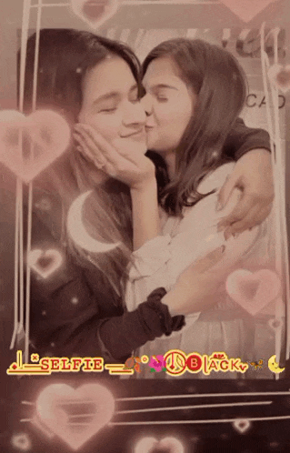 a girl kissing another girl on the cheek in front of a frame that says selfie_black