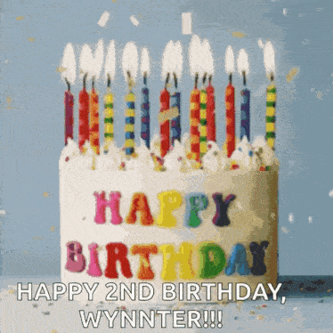 a birthday cake with candles and the words happy 2nd birthday wynnter