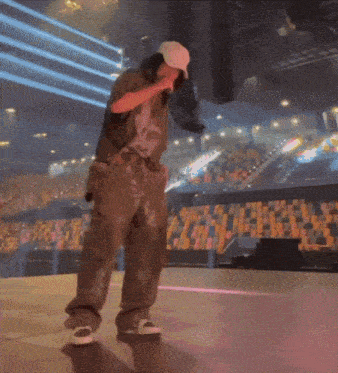 a man is singing into a microphone on stage