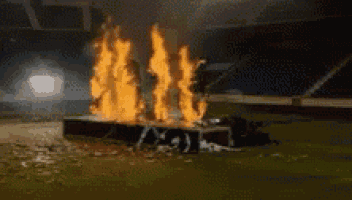 a car is on fire in a stadium .