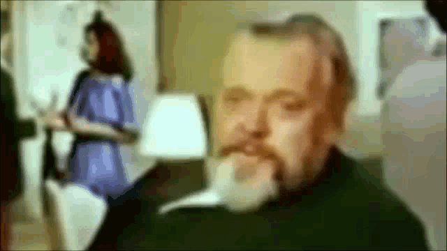 a blurry picture of a man with a white beard
