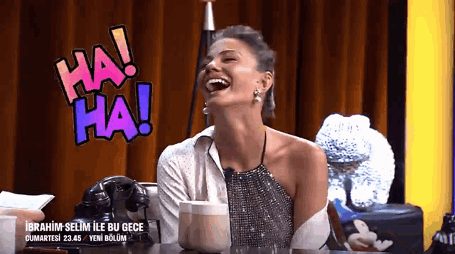 a woman is laughing in front of a sign that says ha ha ha