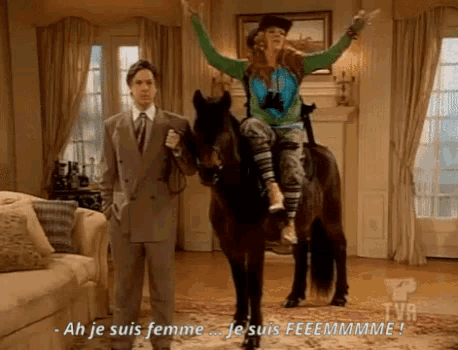 a man in a suit stands next to a woman riding a horse and says ah je suis femme je suis feeemmmme