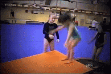 a group of young girls are doing a routine on a trampoline on a tv show called abc