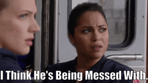 a woman says " i think he 's being messed with " while another woman looks on