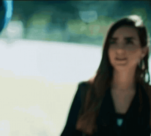 a blurry picture of a woman standing in front of a window
