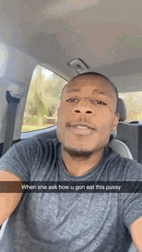 a man is taking a selfie in the back seat of a car while sitting in the driver 's seat .
