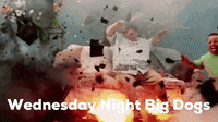 a man is sitting on a couch in front of an explosion with the words wednesday night big dogs