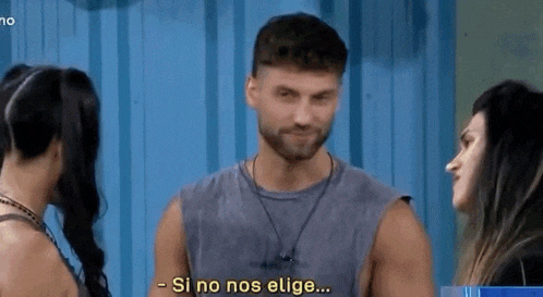 a man with a beard is standing in front of two women and says si no nos elige .