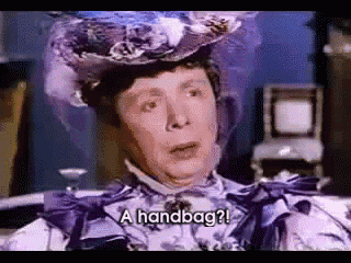 a woman in a purple dress and hat is asking for a handbag