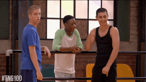 three young men are standing in a gym with the hashtag #tns100 on the bottom