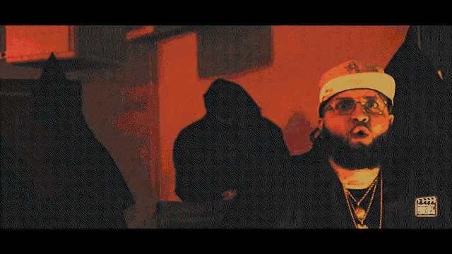 a man with a beard is wearing glasses and a hat that says rsd